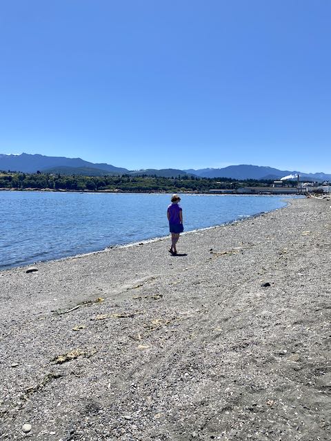 Time in nature is one of the benefits of homeschooling your gifted child. My daughter is walking along the beach away from the camera.