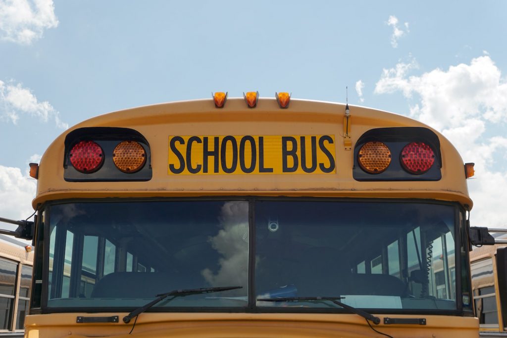 A picture of the front of a yellow school bus. 